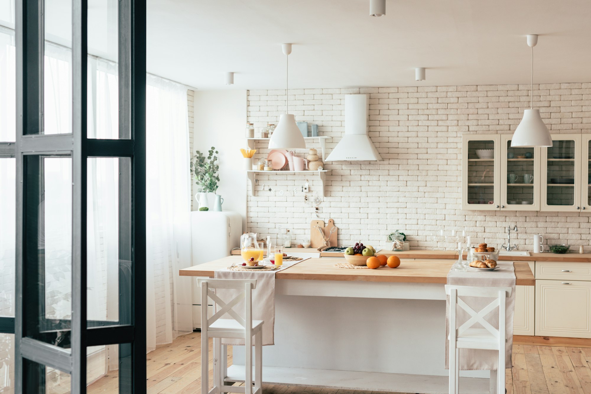 cozy modern kitchen with served table and chairs