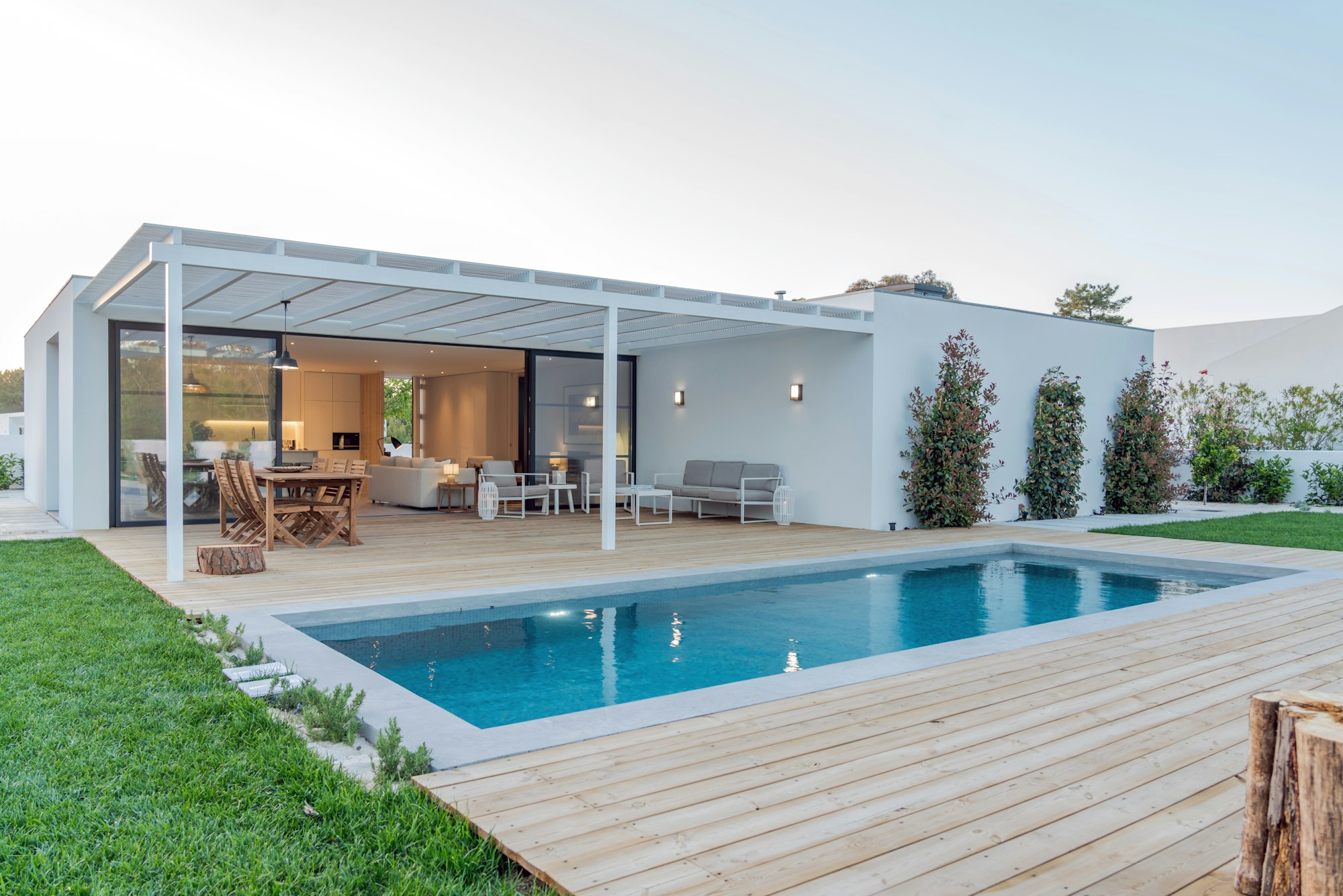 Modern house with garden swimming pool and wooden deck