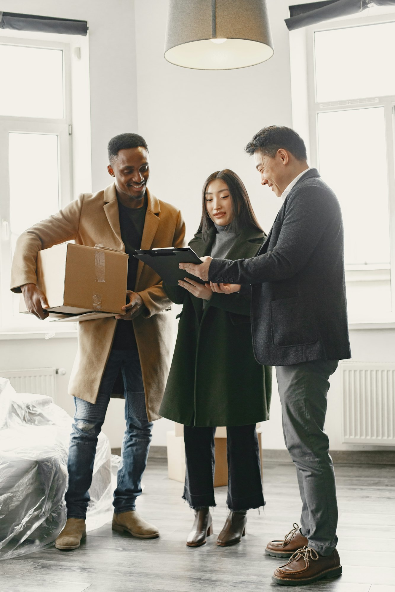 Realtor Explaining Agreement To Couple In New Apartment